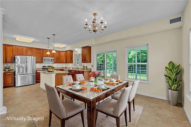 5018 Kings Grant Cir, Suffolk, VA 23434 - dining room with a chandelier, light tile patterned floors, and baseboards