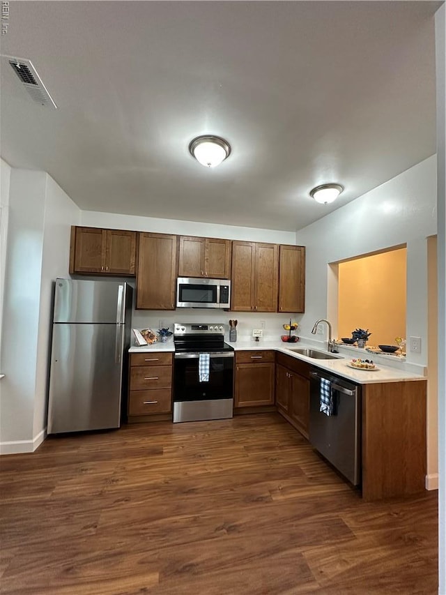 1183 Killington Arch, Chesapeake, VA 23320 - kitchen with stainless steel appliances, a sink, light countertops, and dark wood-style flooring