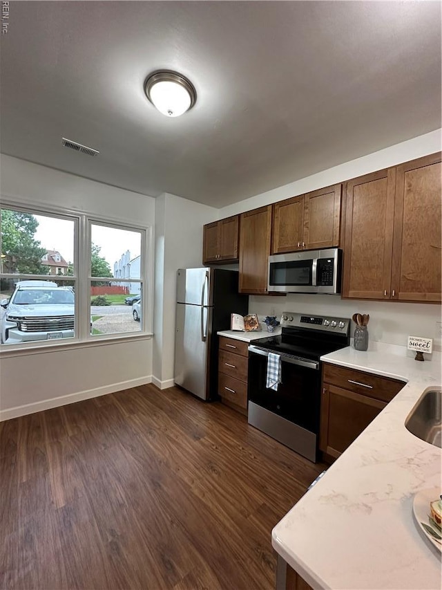 1183 Killington Arch, Chesapeake, VA 23320 - kitchen with appliances with stainless steel finishes, light countertops, dark wood-style flooring, and baseboards