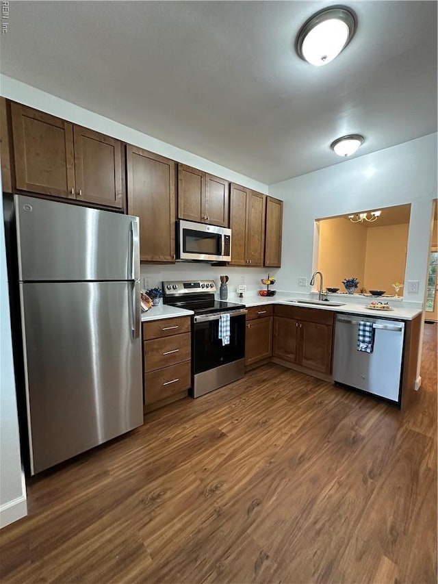1183 Killington Arch, Chesapeake, VA 23320 - kitchen with appliances with stainless steel finishes, a sink, light countertops, and dark wood finished floors