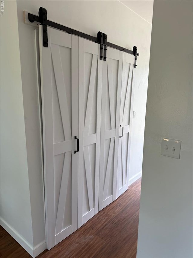 1183 Killington Arch, Chesapeake, VA 23320 - detailed view of a barn door, wood finished floors, and baseboards