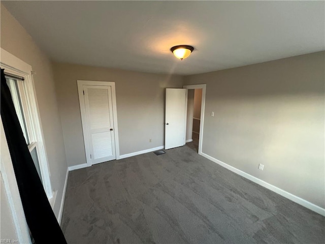 714 B St, Chesapeake, VA 23324 - unfurnished bedroom with baseboards and dark colored carpet