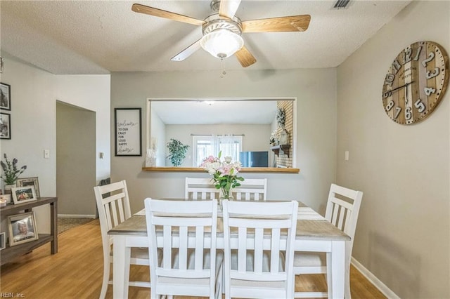 1700 Dylan Dr, Virginia Beach, VA 23464 - dining room with wood finished floors, ceiling fan, baseboards, and a textured ceiling