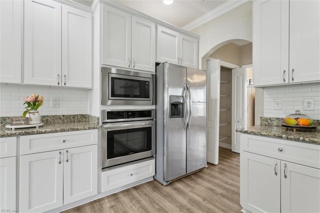 105 Brogden Ct, Hampton, VA 23666 - kitchen featuring stainless steel appliances, arched walkways, crown molding, backsplash, and white cabinetry