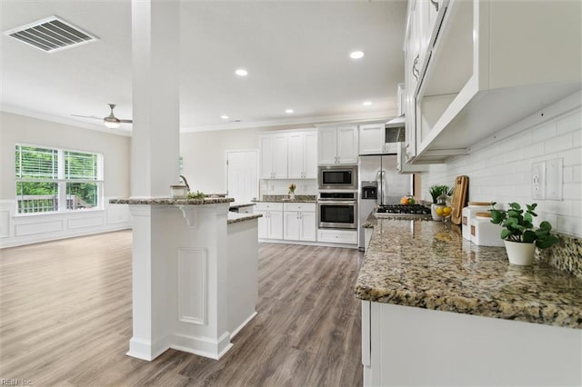 105 Brogden Ct, Hampton, VA 23666 - kitchen featuring stainless steel appliances, crown molding, light wood finished floors, white cabinetry, and light stone countertops