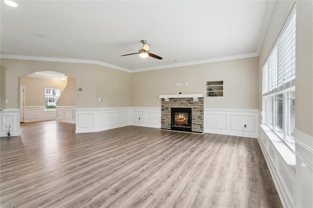 105 Brogden Ct, Hampton, VA 23666 - unfurnished living room featuring arched walkways, ceiling fan, light wood-style flooring, a decorative wall, and crown molding