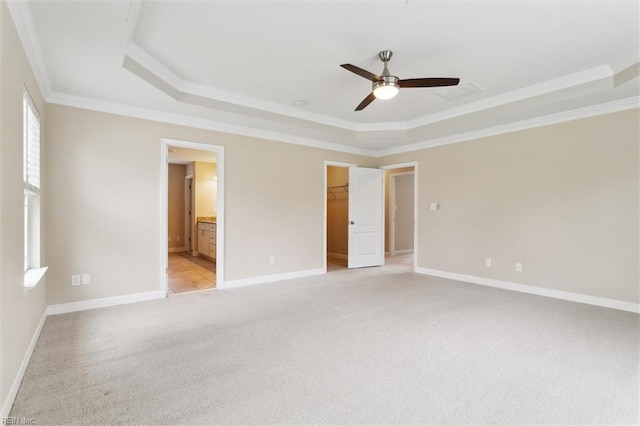 105 Brogden Ct, Hampton, VA 23666 - unfurnished bedroom with a raised ceiling, light carpet, ornamental molding, baseboards, and a walk in closet