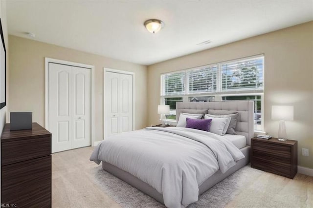 105 Brogden Ct, Hampton, VA 23666 - bedroom with two closets, light carpet, and baseboards