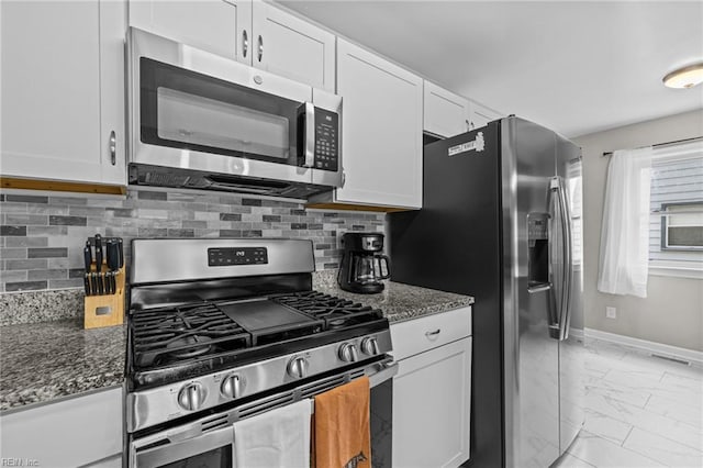 3517 Bessie St, Norfolk, VA 23513 - kitchen with appliances with stainless steel finishes, light marble finish flooring, dark stone counters, and white cabinetry