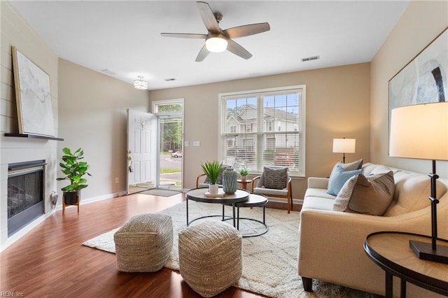711 Windbrook Cir, Newport News, VA 23606 - living area with wood finished floors, a fireplace, a ceiling fan, and baseboards