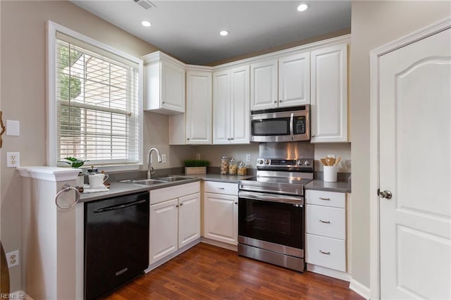 711 Windbrook Cir, Newport News, VA 23606 - kitchen with appliances with stainless steel finishes, a sink, dark wood-style flooring, white cabinets, and recessed lighting