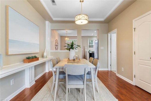 711 Windbrook Cir, Newport News, VA 23606 - dining room with wood finished floors, a tray ceiling, baseboards, and ornamental molding