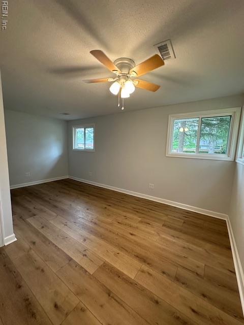 128 Ridgewood Rd, Chesapeake, VA 23325 - empty room featuring hardwood / wood-style flooring, baseboards, ceiling fan, and a textured ceiling