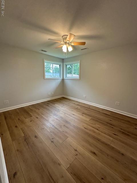 128 Ridgewood Rd, Chesapeake, VA 23325 - spare room with dark wood finished floors, a ceiling fan, and baseboards