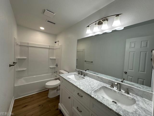 128 Ridgewood Rd, Chesapeake, VA 23325 - bathroom featuring wood finished floors, toilet, double vanity, and tub / shower combination