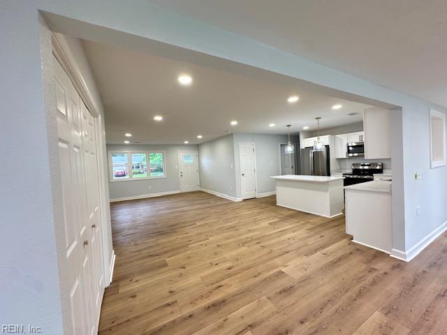 128 Ridgewood Rd, Chesapeake, VA 23325 - unfurnished living room with baseboards, recessed lighting, and light wood-type flooring