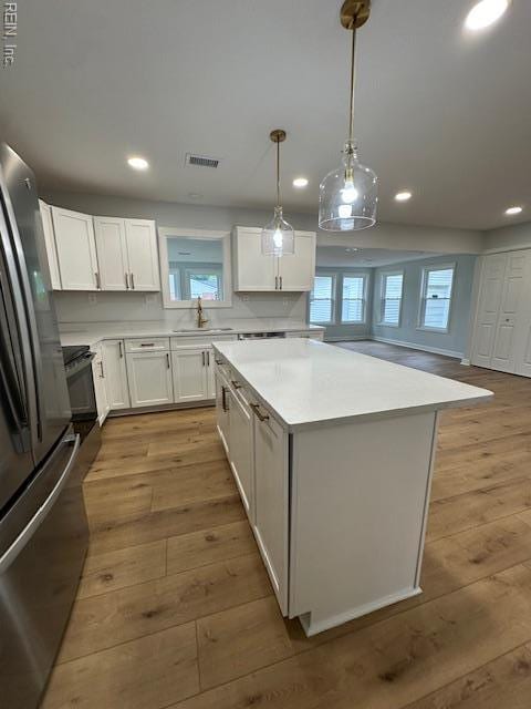 128 Ridgewood Rd, Chesapeake, VA 23325 - kitchen featuring hardwood / wood-style flooring, freestanding refrigerator, a center island, a sink, and recessed lighting