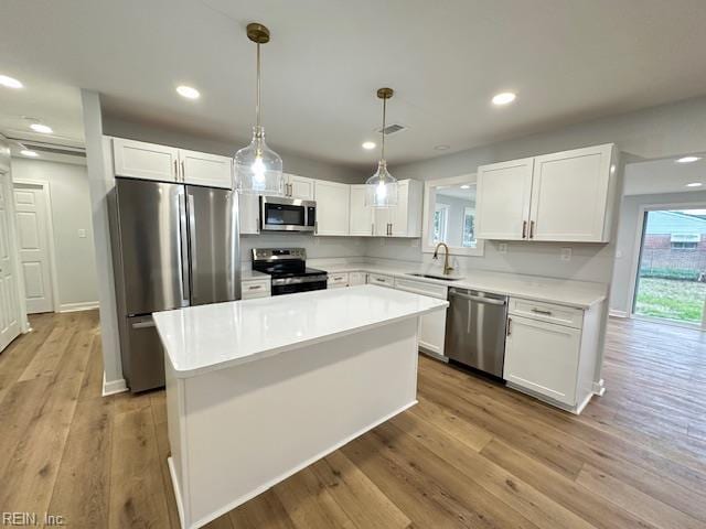 128 Ridgewood Rd, Chesapeake, VA 23325 - kitchen featuring appliances with stainless steel finishes, a sink, white cabinetry, light wood-type flooring, and recessed lighting