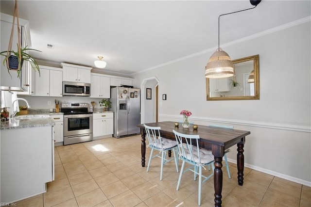 740 Hilda Pine Dr, Chesapeake, VA 23322 - kitchen featuring stainless steel appliances, light tile patterned floors, a sink, crown molding, and white cabinets