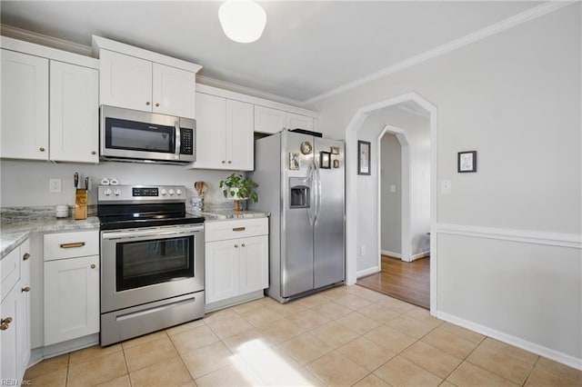 740 Hilda Pine Dr, Chesapeake, VA 23322 - kitchen with stainless steel appliances, ornamental molding, light tile patterned flooring, white cabinetry, and arched walkways