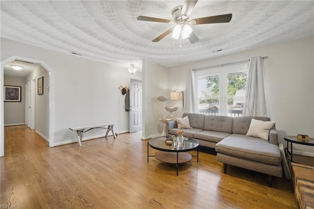 740 Hilda Pine Dr, Chesapeake, VA 23322 - living area featuring a ceiling fan, arched walkways, wood finished floors, and baseboards