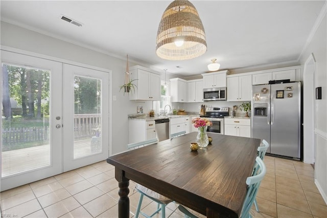 740 Hilda Pine Dr, Chesapeake, VA 23322 - dining area with light tile patterned floors, french doors, and ornamental molding