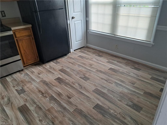 800 Pencil Box Way, Virginia Beach, VA 23462 - kitchen with stainless steel range with electric cooktop, freestanding refrigerator, light wood-style flooring, brown cabinets, and baseboards