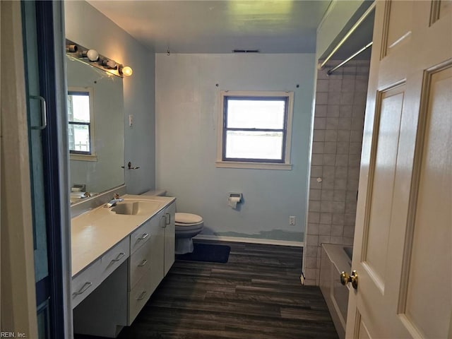 13443 Buckland Way, Painter, VA 23420 - bathroom featuring vanity, wood finished floors, plenty of natural light, and toilet