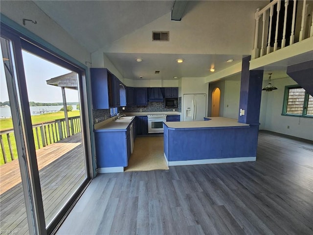13443 Buckland Way, Painter, VA 23420 - kitchen with white refrigerator with ice dispenser, arched walkways, wood finished floors, backsplash, and a sink