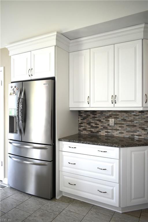 1176 Pond Cypress Dr, Virginia Beach, VA 23455 - kitchen featuring stainless steel refrigerator with ice dispenser, backsplash, white cabinetry, and dark stone counters