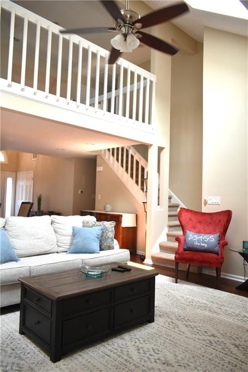 1176 Pond Cypress Dr, Virginia Beach, VA 23455 - living area featuring a ceiling fan, baseboards, stairs, and a towering ceiling