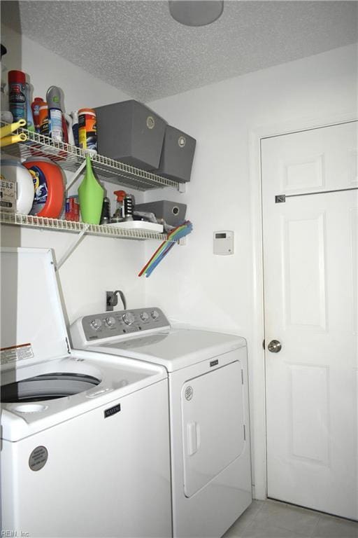 1176 Pond Cypress Dr, Virginia Beach, VA 23455 - laundry room featuring separate washer and dryer, light tile patterned flooring, and a textured ceiling