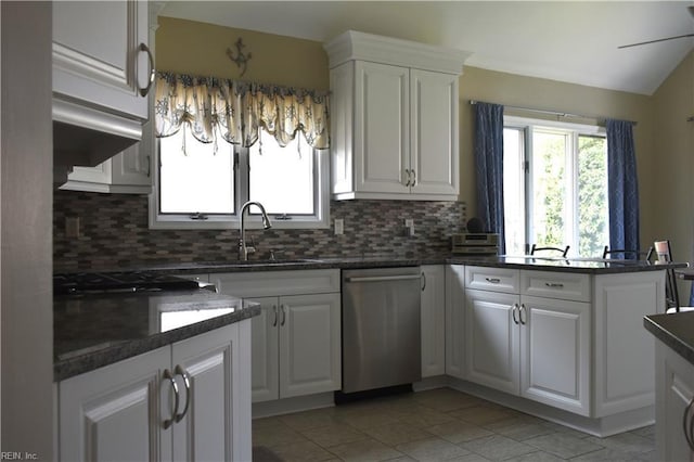 1176 Pond Cypress Dr, Virginia Beach, VA 23455 - kitchen with stainless steel dishwasher, tasteful backsplash, white cabinetry, light tile patterned floors, and a sink