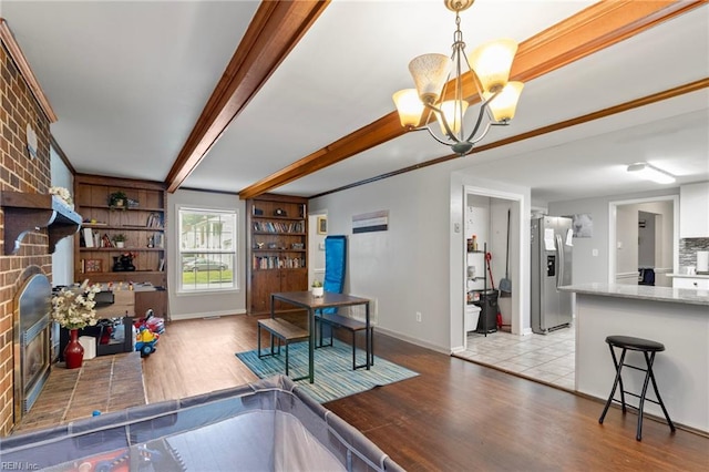 744 Village Green Pkwy, Newport News, VA 23602 - dining area featuring a chandelier, wood finished floors, a fireplace, baseboards, and beam ceiling