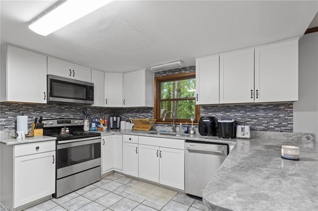 744 Village Green Pkwy, Newport News, VA 23602 - kitchen with stainless steel appliances, a sink, light countertops, backsplash, and light tile patterned floors