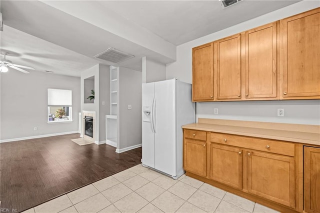 408 Coastal Walk Pl Unit 102, Virginia Beach, VA 23451 - kitchen with white fridge with ice dispenser, light countertops, open floor plan, ceiling fan, and brown cabinets