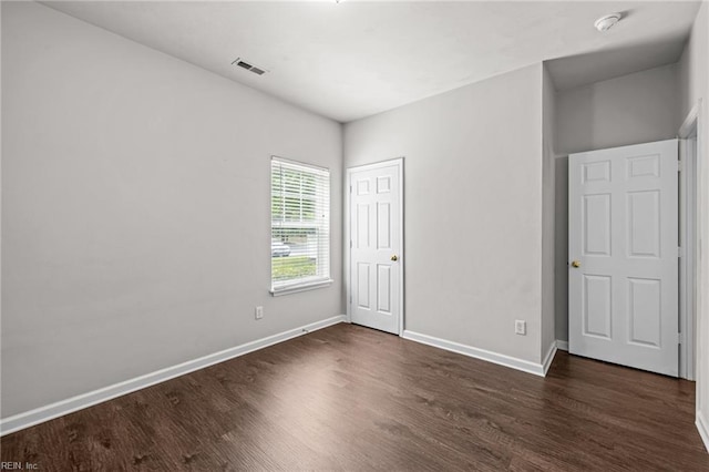 408 Coastal Walk Pl Unit 102, Virginia Beach, VA 23451 - unfurnished bedroom with dark wood-style flooring, baseboards, and a closet