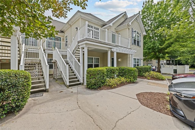 408 Coastal Walk Pl Unit 102, Virginia Beach, VA 23451 - view of front of house featuring stairs and a shingled roof