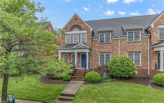 106 Edith Wharton Sq, Newport News, VA 23606 - view of front facade with a front yard, brick siding, and roof with shingles