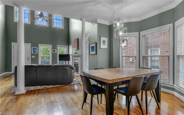 106 Edith Wharton Sq, Newport News, VA 23606 - dining space featuring decorative columns, a ceiling fan, wood finished floors, a fireplace, and crown molding