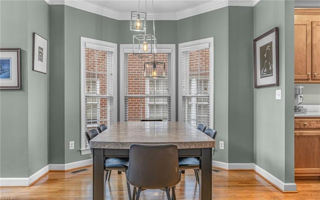 106 Edith Wharton Sq, Newport News, VA 23606 - dining room with light wood finished floors, baseboards, and ornamental molding