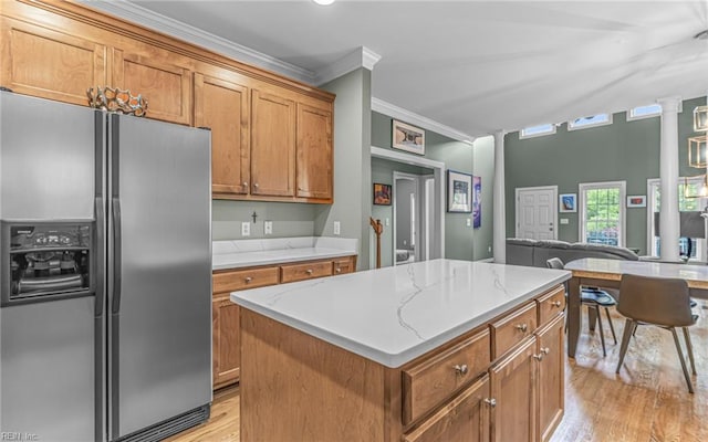 106 Edith Wharton Sq, Newport News, VA 23606 - kitchen featuring stainless steel refrigerator with ice dispenser, ornamental molding, light wood-style floors, brown cabinets, and a kitchen island