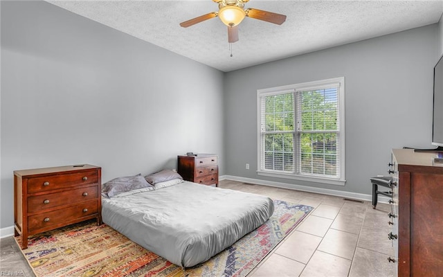 106 Edith Wharton Sq, Newport News, VA 23606 - bedroom with a textured ceiling, baseboards, light tile patterned floors, and ceiling fan