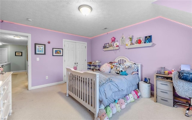106 Edith Wharton Sq, Newport News, VA 23606 - bedroom featuring light colored carpet, a textured ceiling, a closet, and baseboards