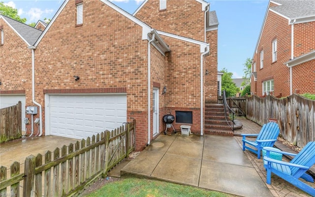 106 Edith Wharton Sq, Newport News, VA 23606 - back of house with brick siding, a garage, a fenced backyard, and concrete driveway