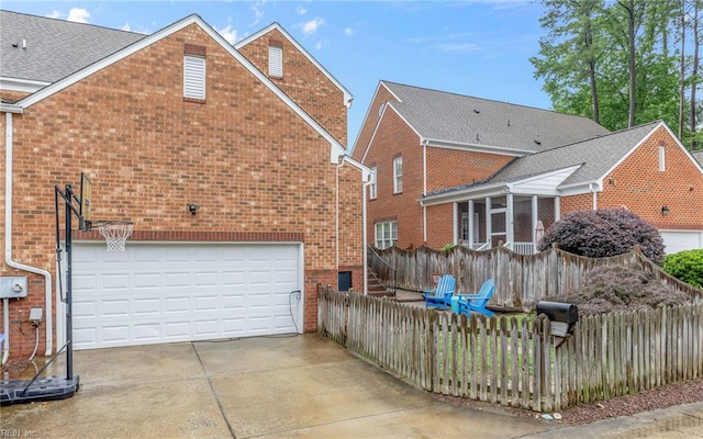 106 Edith Wharton Sq, Newport News, VA 23606 - back of property with brick siding, driveway, and an attached garage