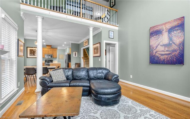 106 Edith Wharton Sq, Newport News, VA 23606 - living room featuring decorative columns, light wood-style flooring, ornamental molding, baseboards, and recessed lighting