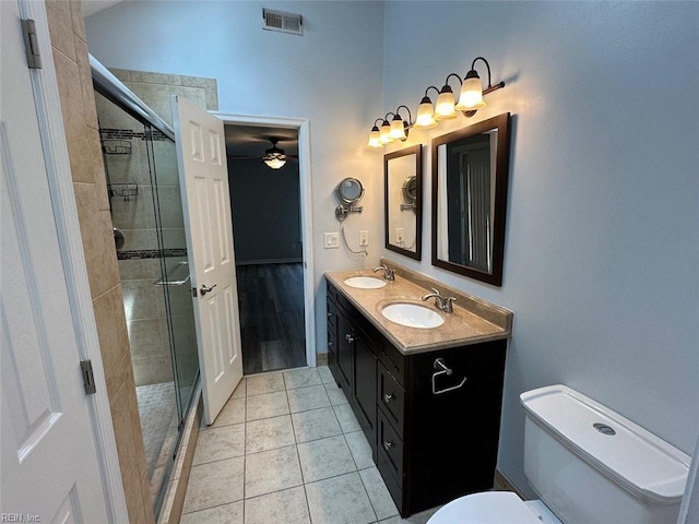 2304 Londale Ct, Virginia Beach, VA 23456 - full bathroom with double vanity, a ceiling fan, toilet, a stall shower, and tile patterned floors