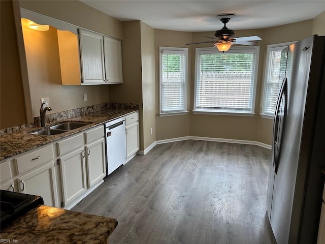 2304 Londale Ct, Virginia Beach, VA 23456 - kitchen featuring dishwasher, a sink, freestanding refrigerator, a ceiling fan, and wood finished floors