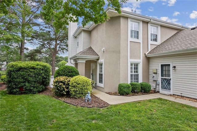 947 Willow Pt, Newport News, VA 23602 - view of side of home featuring a shingled roof, a chimney, a lawn, and stucco siding